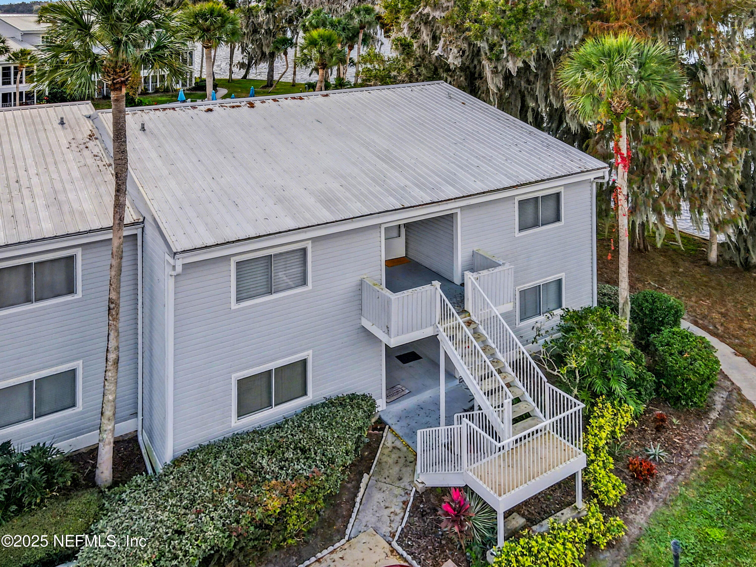 102 River Bend Road, Unit A Welaka, FL 32193 - Photo 2 of 39 a aerial view of a house with a yard and potted plants