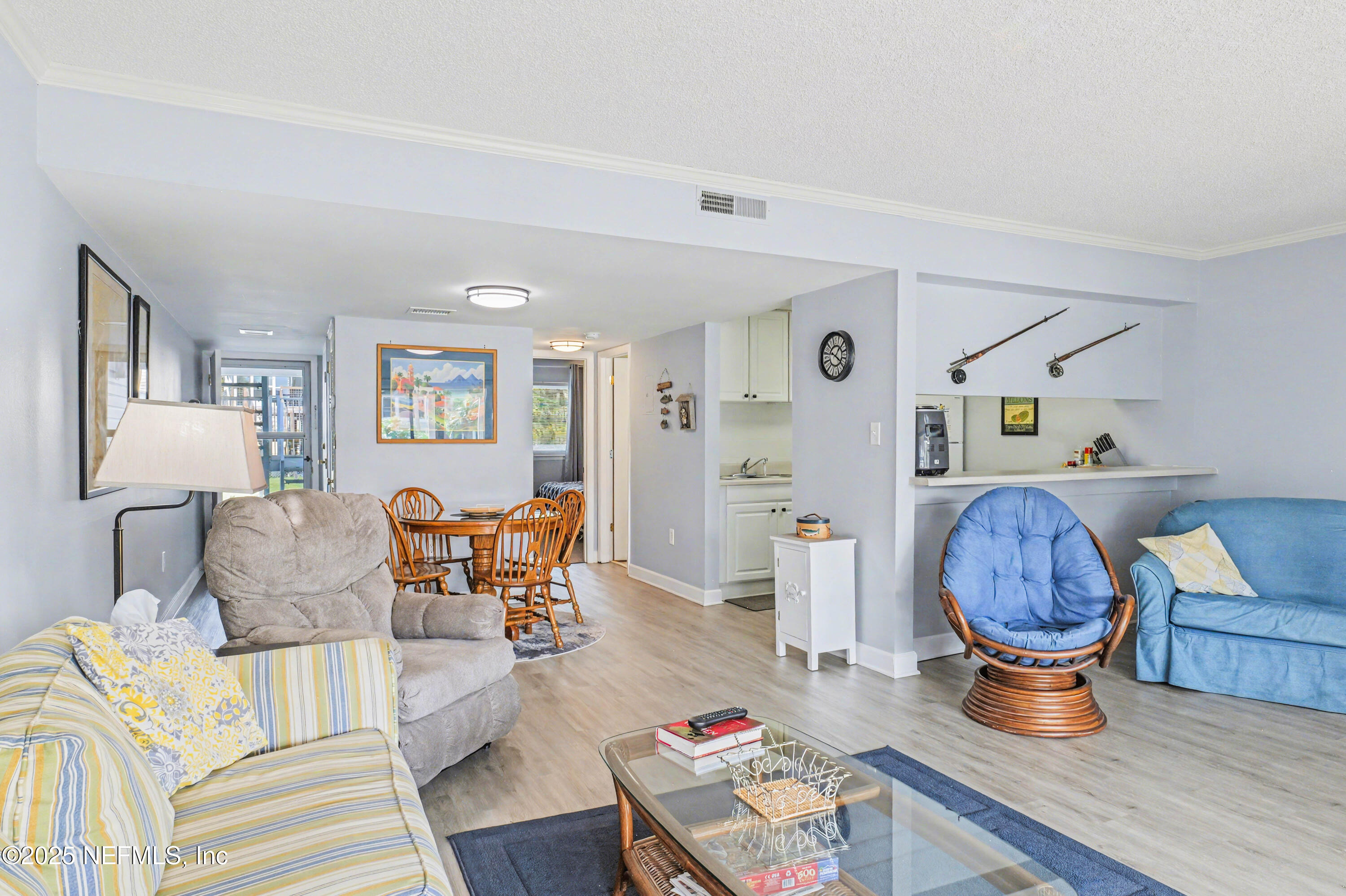 102 River Bend Road, Unit A Welaka, FL 32193 - Photo 25 of 39 a living room with furniture a rug and a lamp
