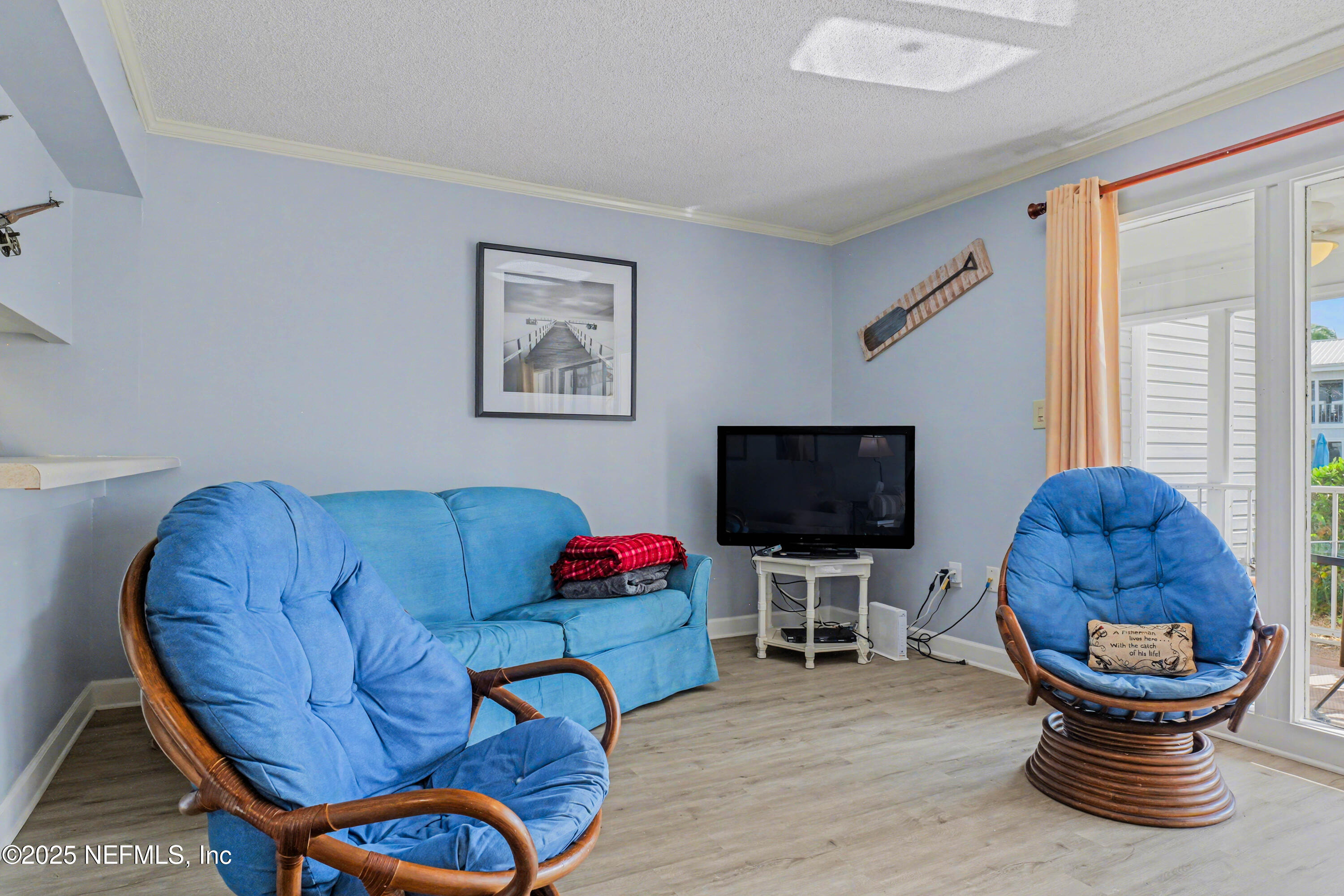102 River Bend Road, Unit A Welaka, FL 32193 - Photo 29 of 39 a living room with furniture and a flat screen tv