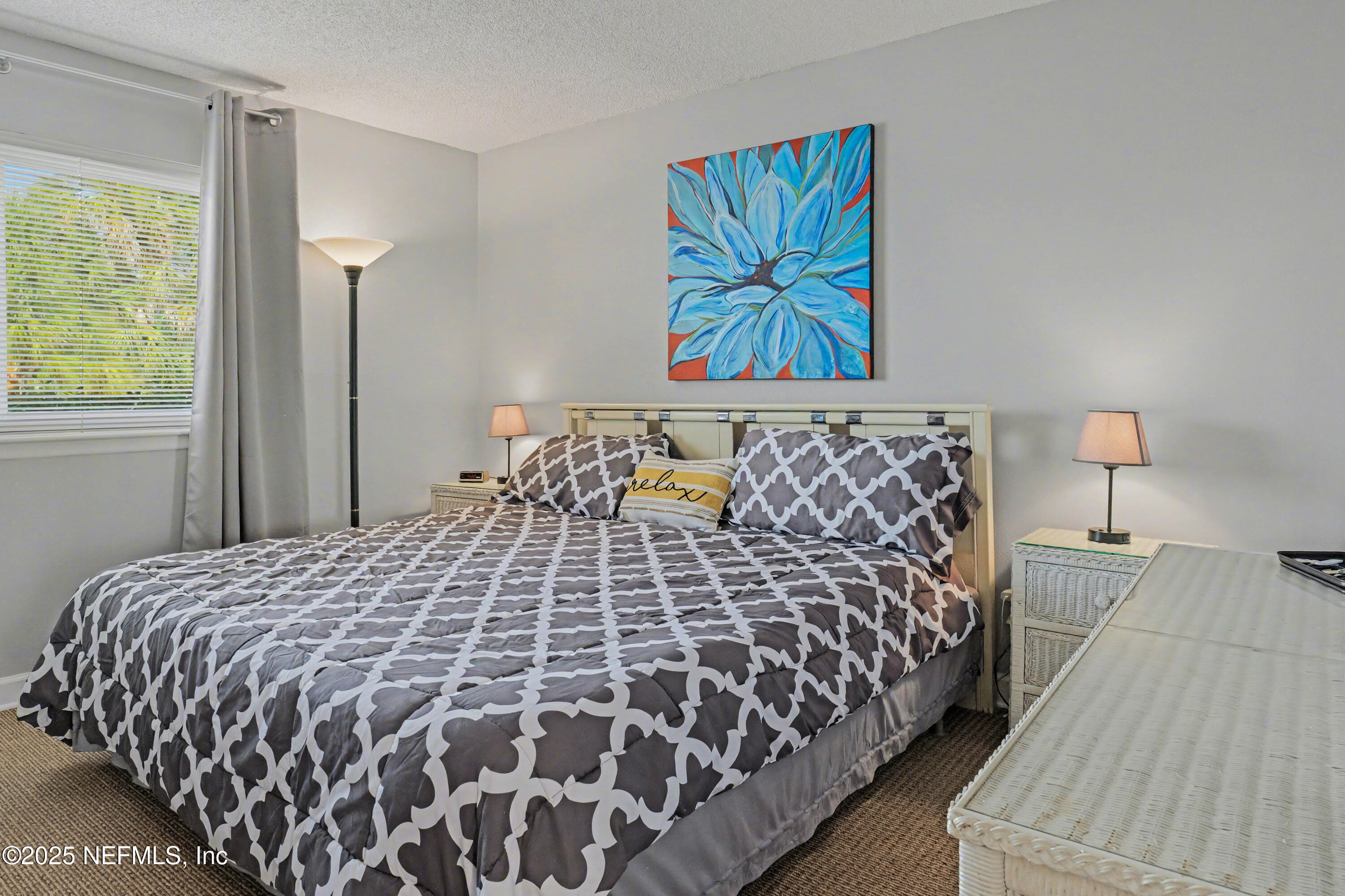 102 River Bend Road, Unit A Welaka, FL 32193 - Photo 30 of 39 a large bed sitting in a bedroom next to a window