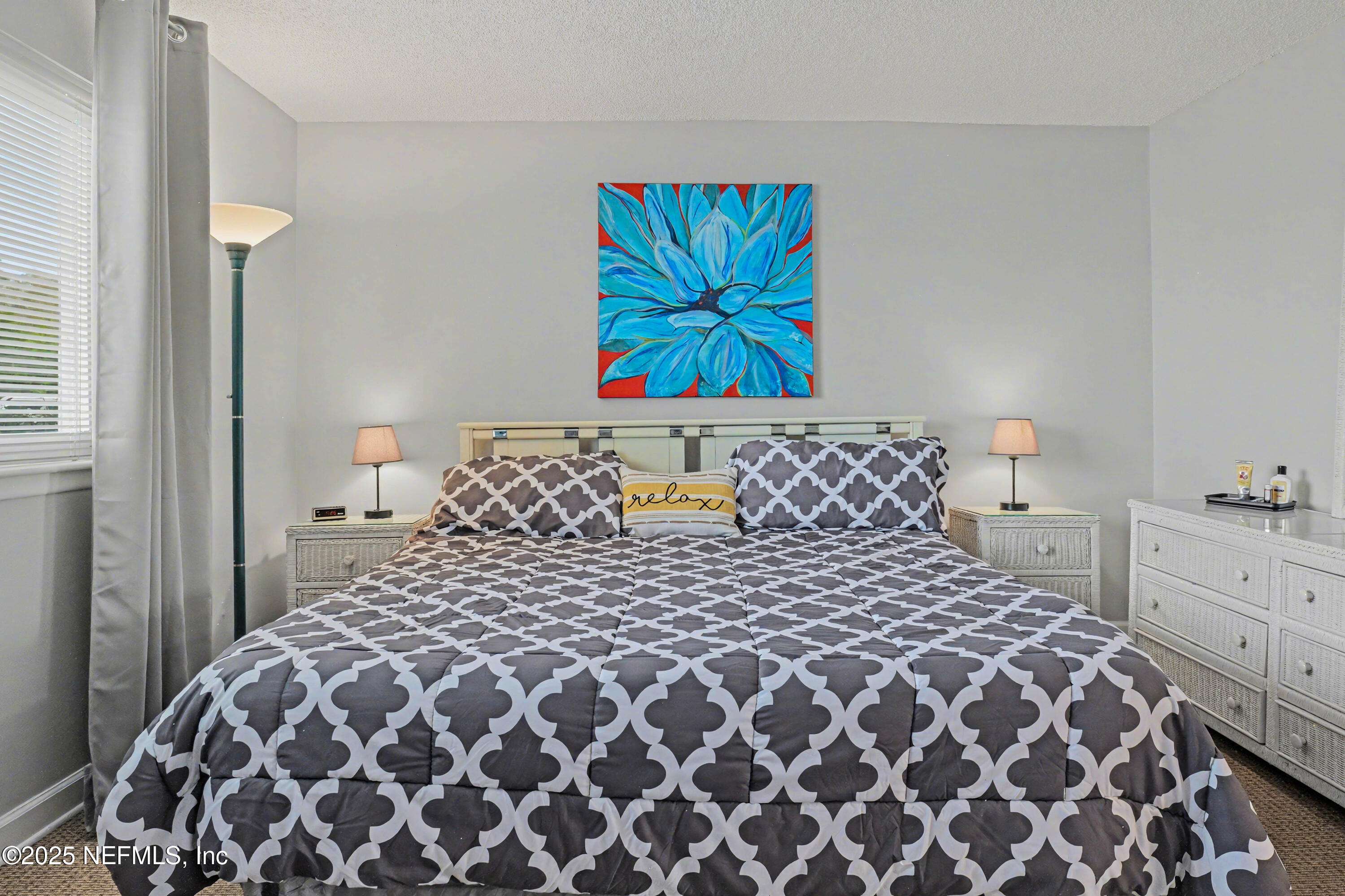 102 River Bend Road, Unit A Welaka, FL 32193 - Photo 31 of 39 a large bed sitting in a bedroom next to a window