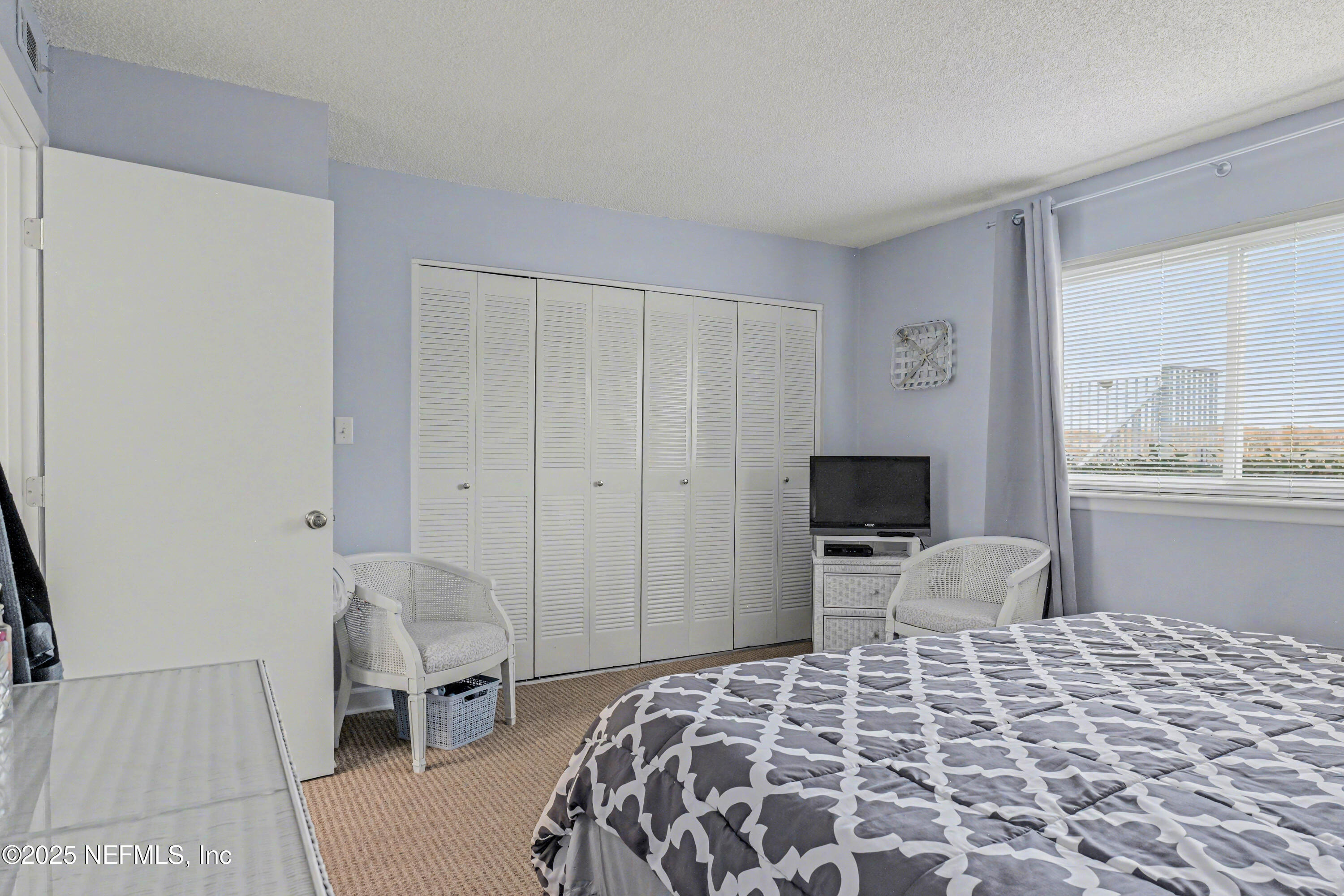 102 River Bend Road, Unit A Welaka, FL 32193 - Photo 32 of 39 a bedroom with a bed and wooden floor