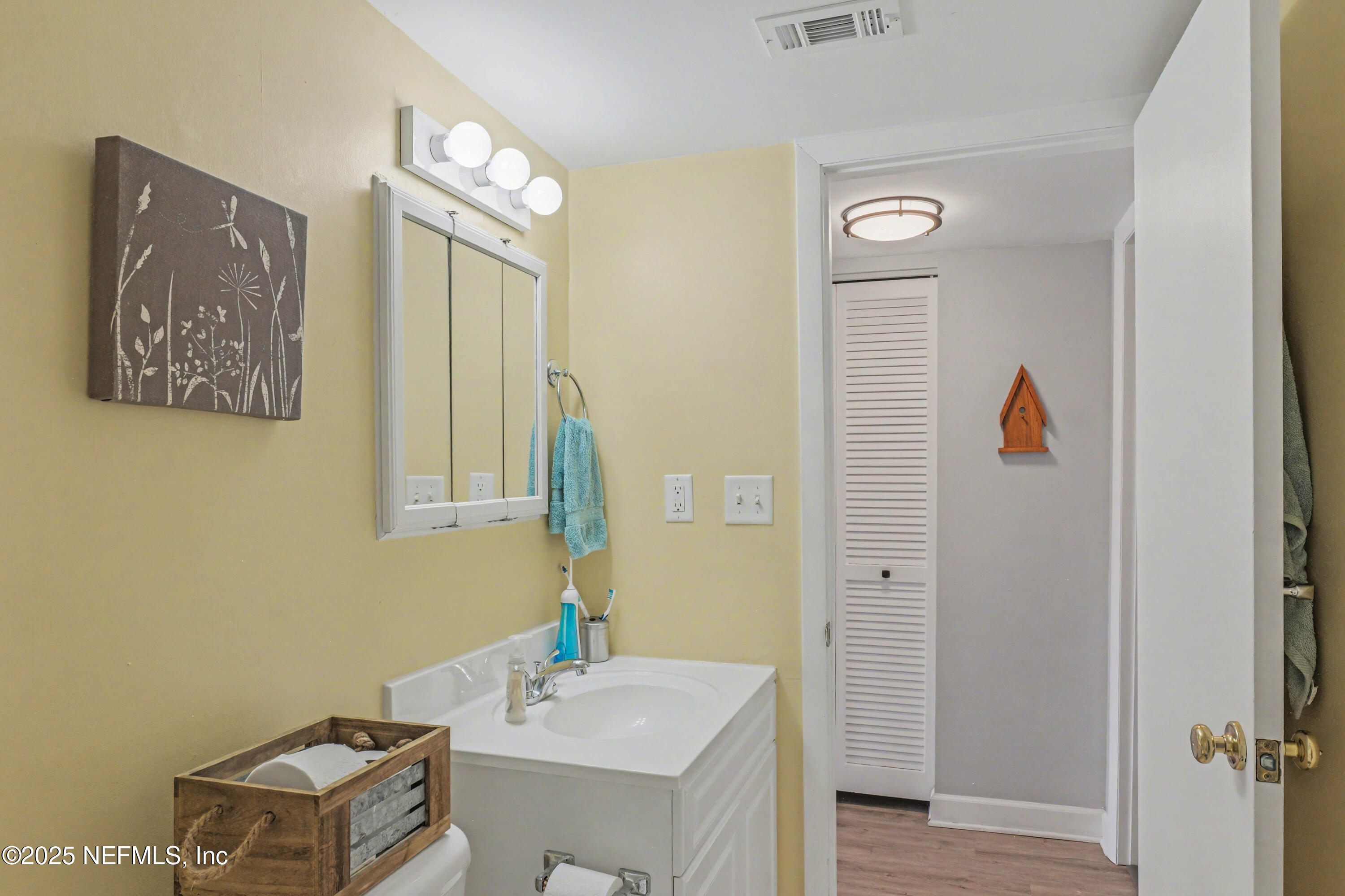 102 River Bend Road, Unit A Welaka, FL 32193 - Photo 34 of 39 a bathroom with a sink a mirror and a toilet