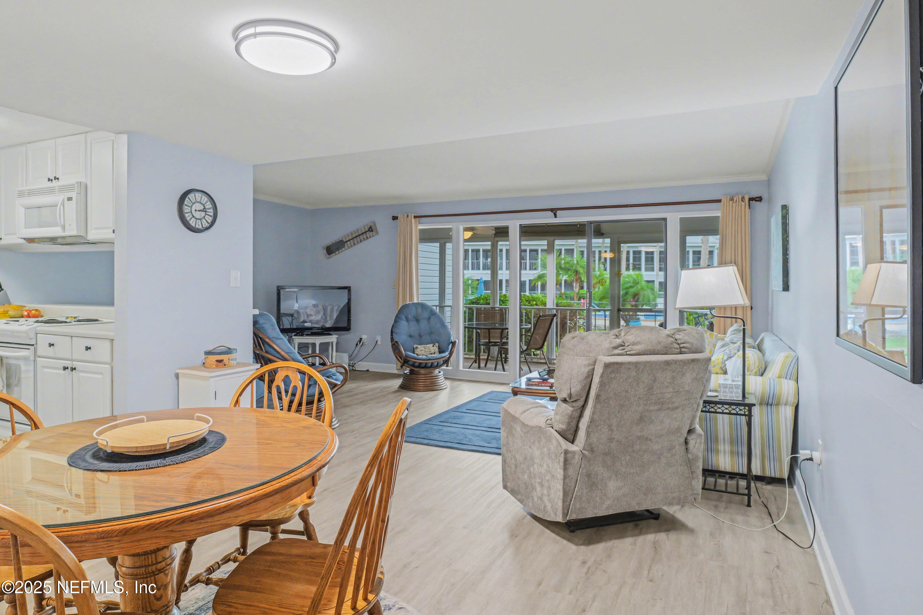 102 River Bend Road, Unit A Welaka, FL 32193 - Photo 35 of 39 a living room with furniture and a floor to ceiling window