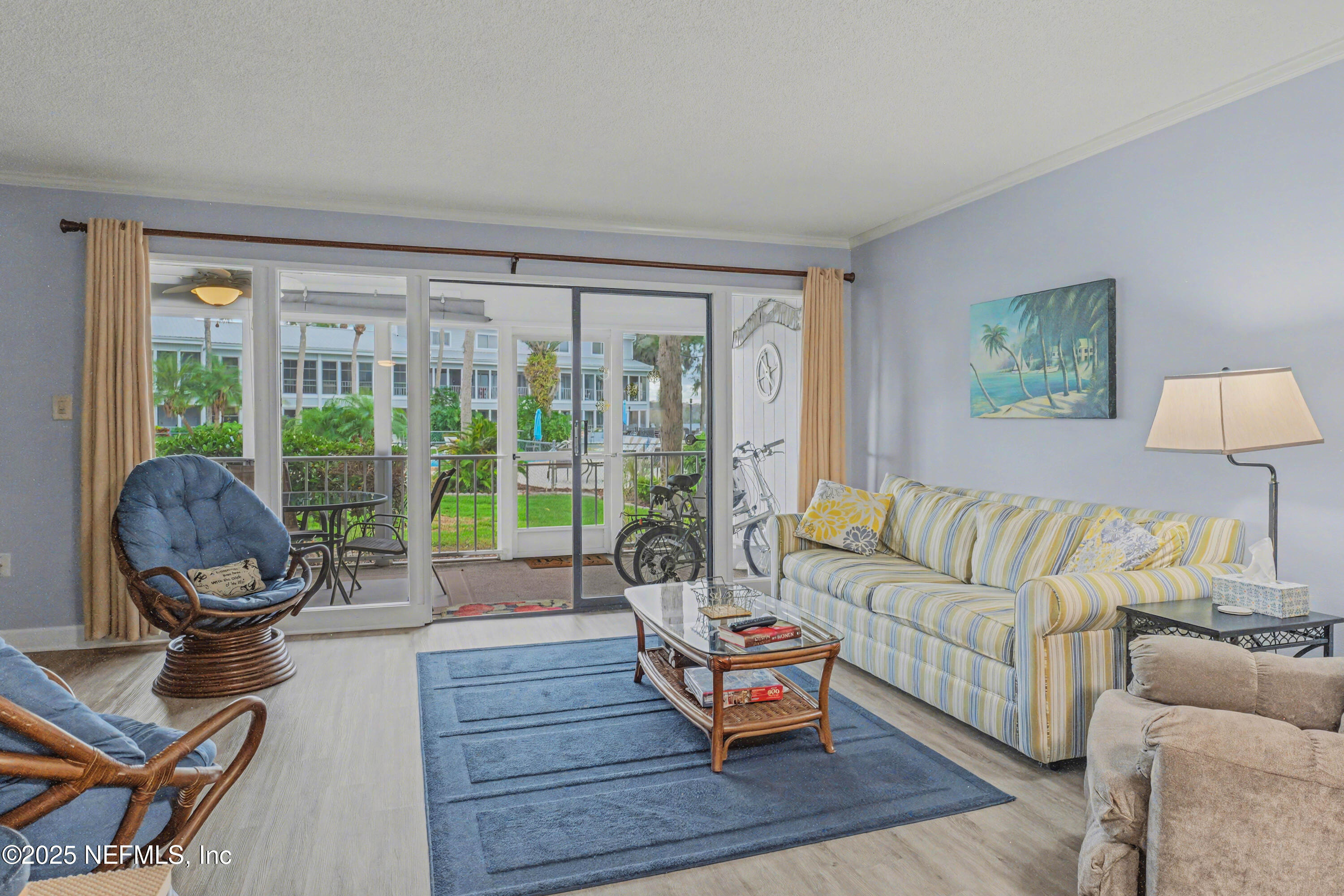 102 River Bend Road, Unit A Welaka, FL 32193 - Photo 37 of 39 a living room with furniture a table and a large window
