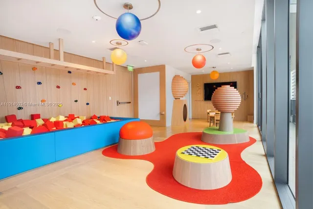 a living room with furniture and large windows