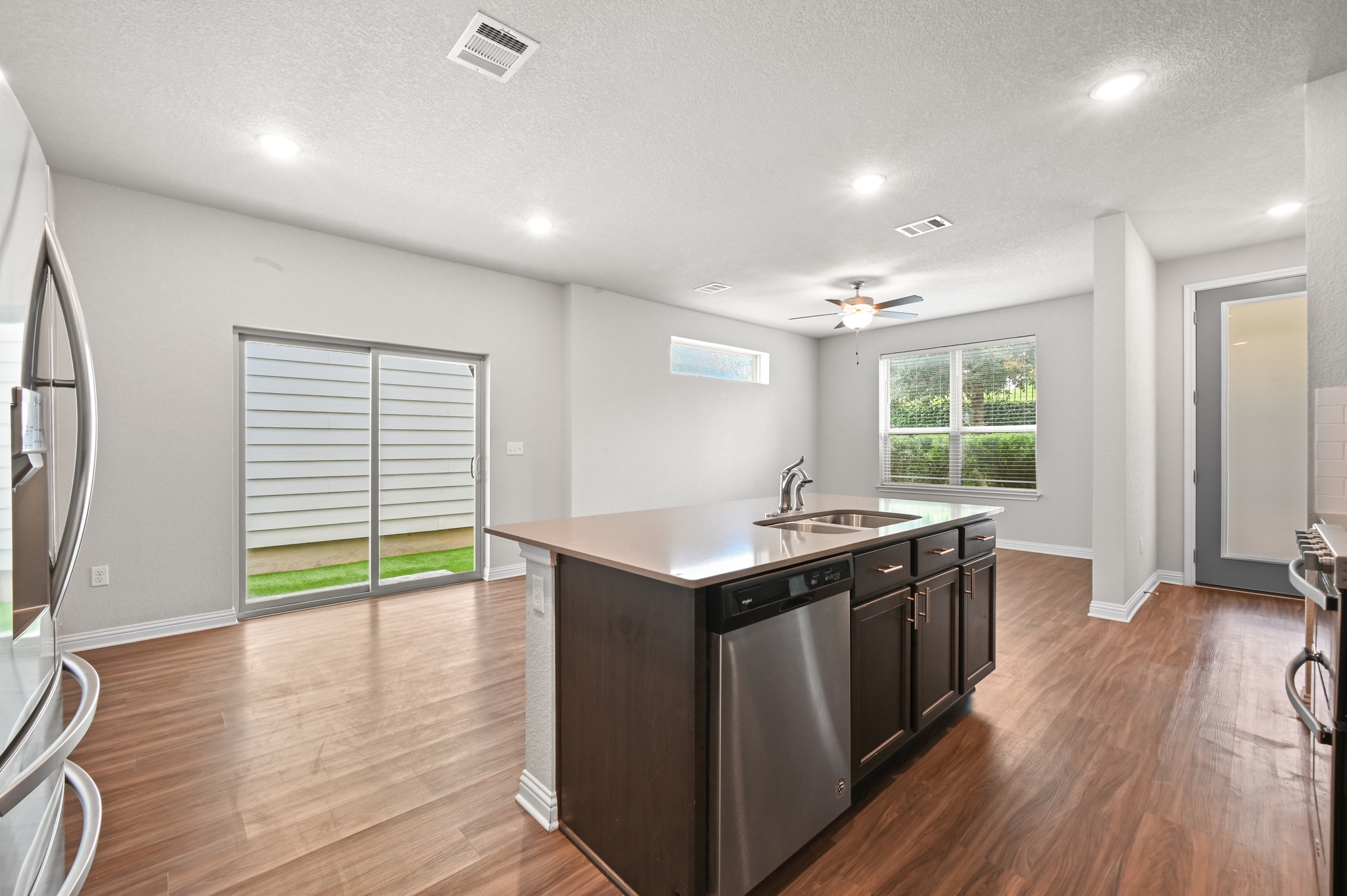 8201 Frida Bend Austin, TX 78744 - Photo 17 of 29 An open-concept living space with a contemporary kitchen island and gleaming hardwood floors.