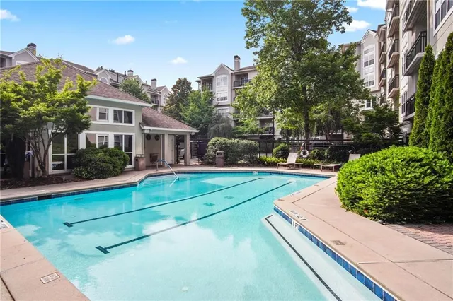 a view of a house with pool and sitting area