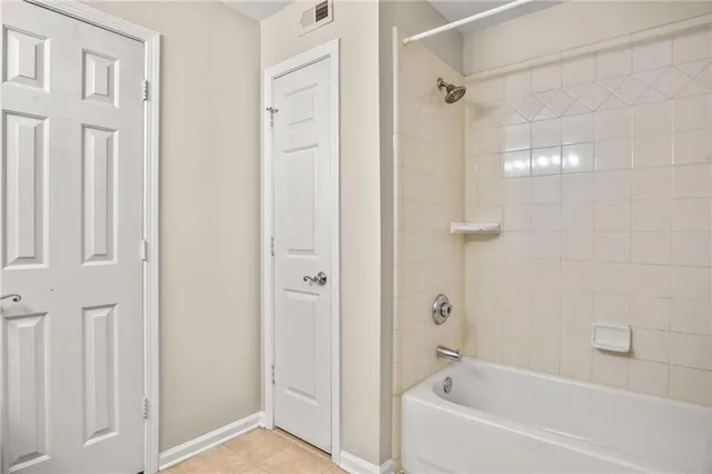 a white bath tub sitting next to a shower