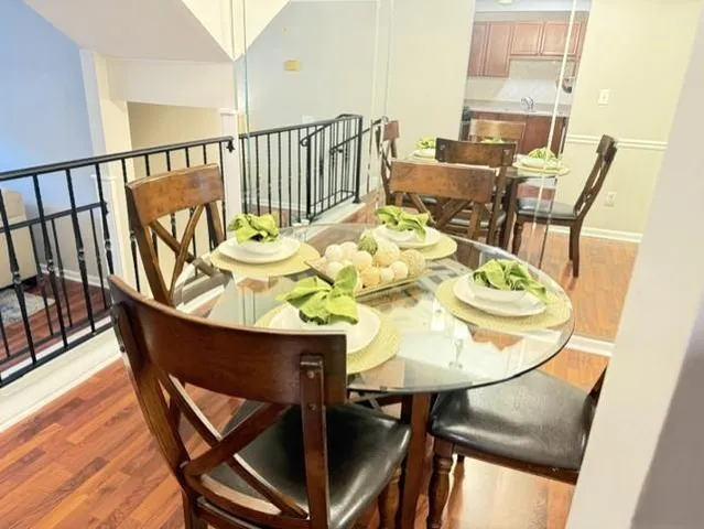 a view of a dining room with furniture and wooden floor