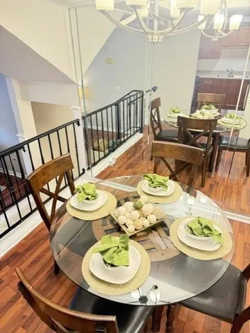a dining room with furniture and wooden floor