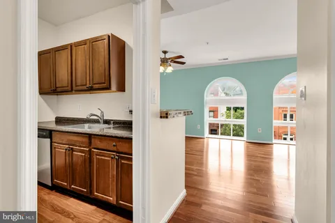 a view of a kitchen with stainless steel appliances granite countertop a stove and a refrigerator
