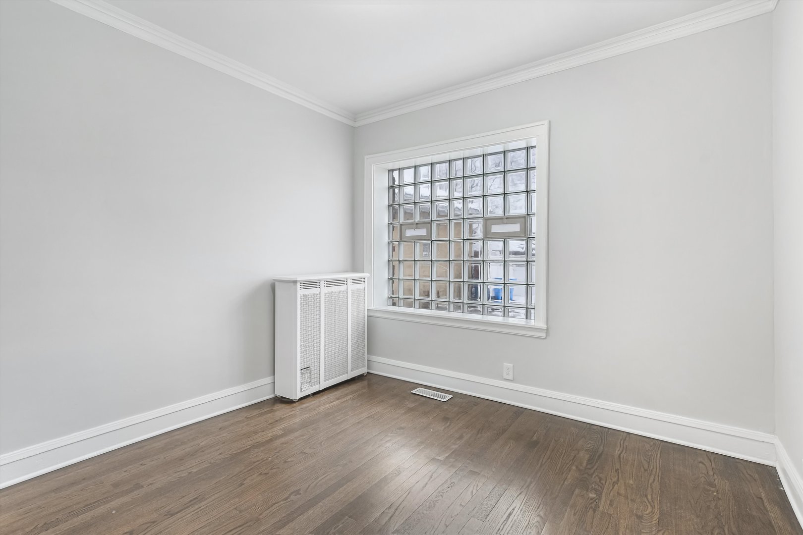 11340 South Union Avenue Chicago, IL 60628 - Photo 7 of 27 an empty room with wooden floor and window