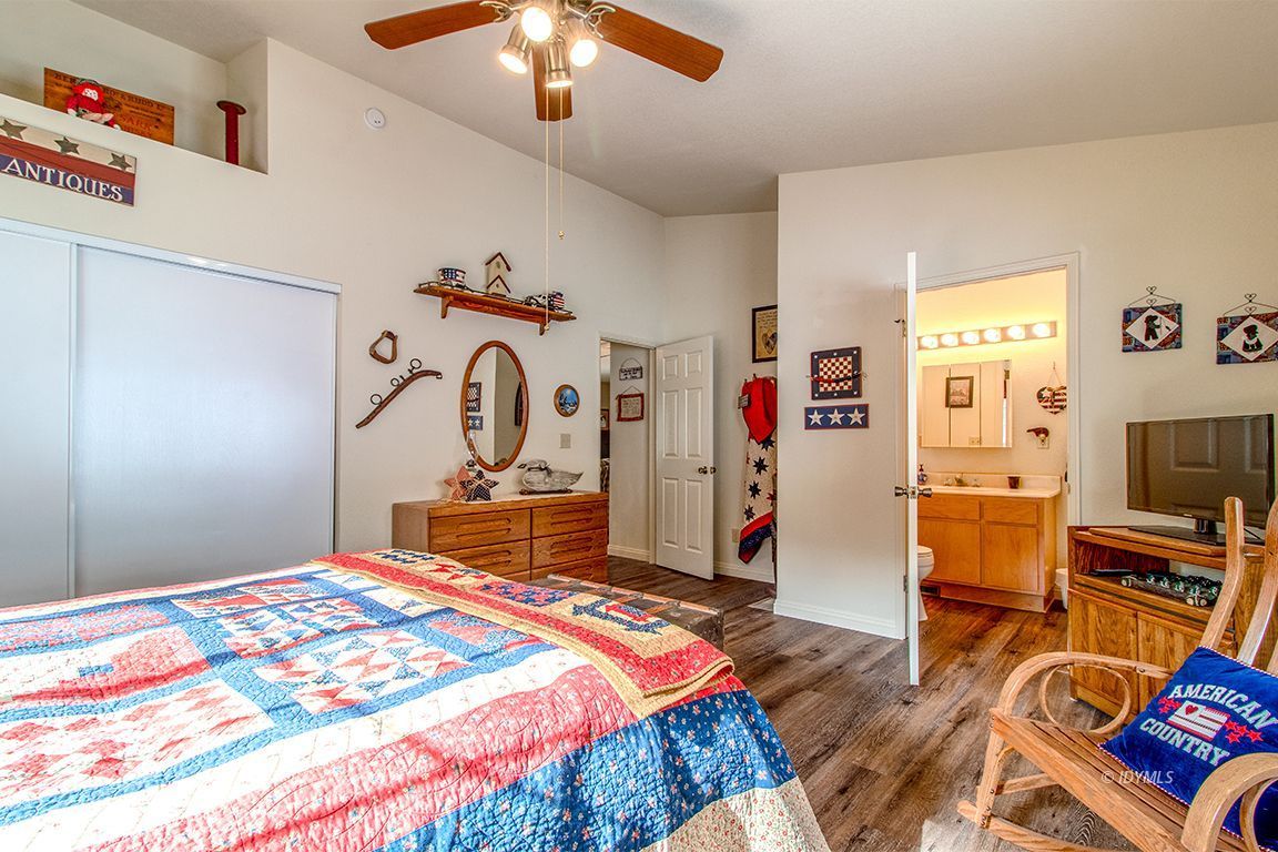 25244 Cougar Road Idyllwild, CA 92549 - Photo 22 of 32 a bedroom with bed and a chandelier