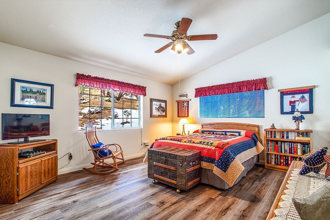 25244 Cougar Road Idyllwild, CA 92549 - Photo 23 of 32 a bedroom with a bed and wooden floor
