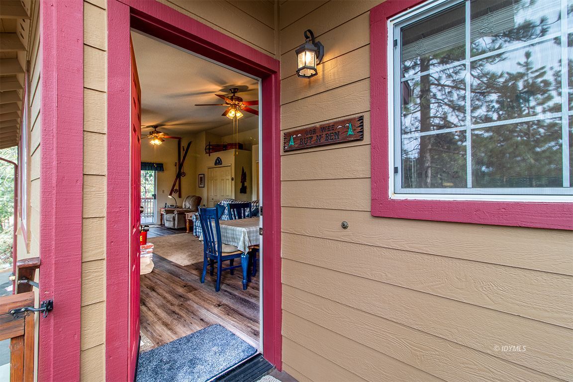 25244 Cougar Road Idyllwild, CA 92549 - Photo 7 of 32 a view of a balcony with red door and brick walls