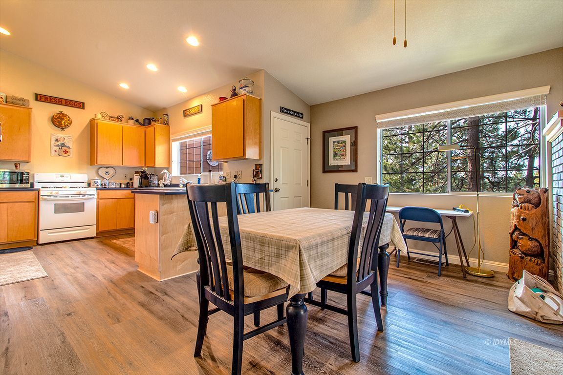 25244 Cougar Road Idyllwild, CA 92549 - Photo 8 of 32 a view of a dining room with furniture window and wooden floor
