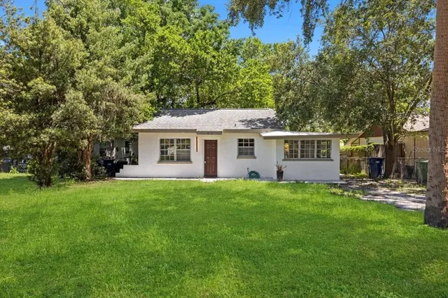 a view of a yard with a house and a garden