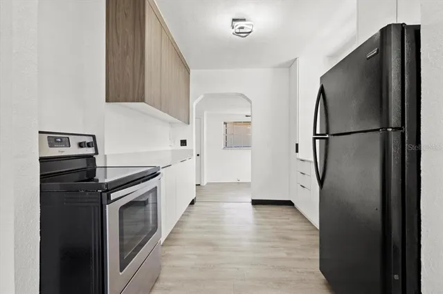 a kitchen with a refrigerator and a stove