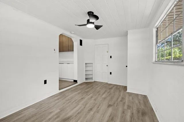 a view of empty room with wooden floor