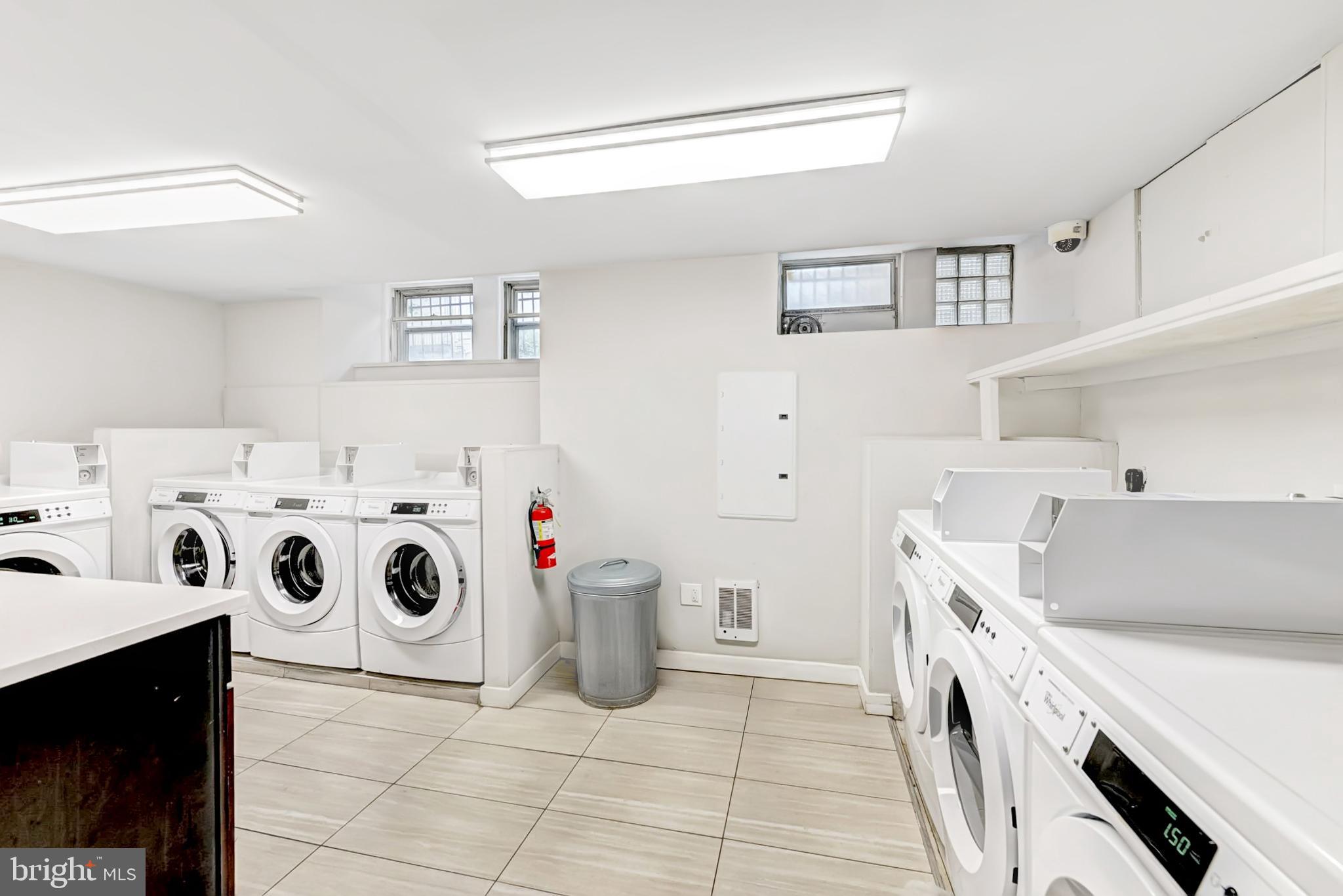 4605 Chester Avenue, Unit STUDIO Philadelphia, PA 19143 - Photo 12 of 12 a utility room with dryer washer and sink