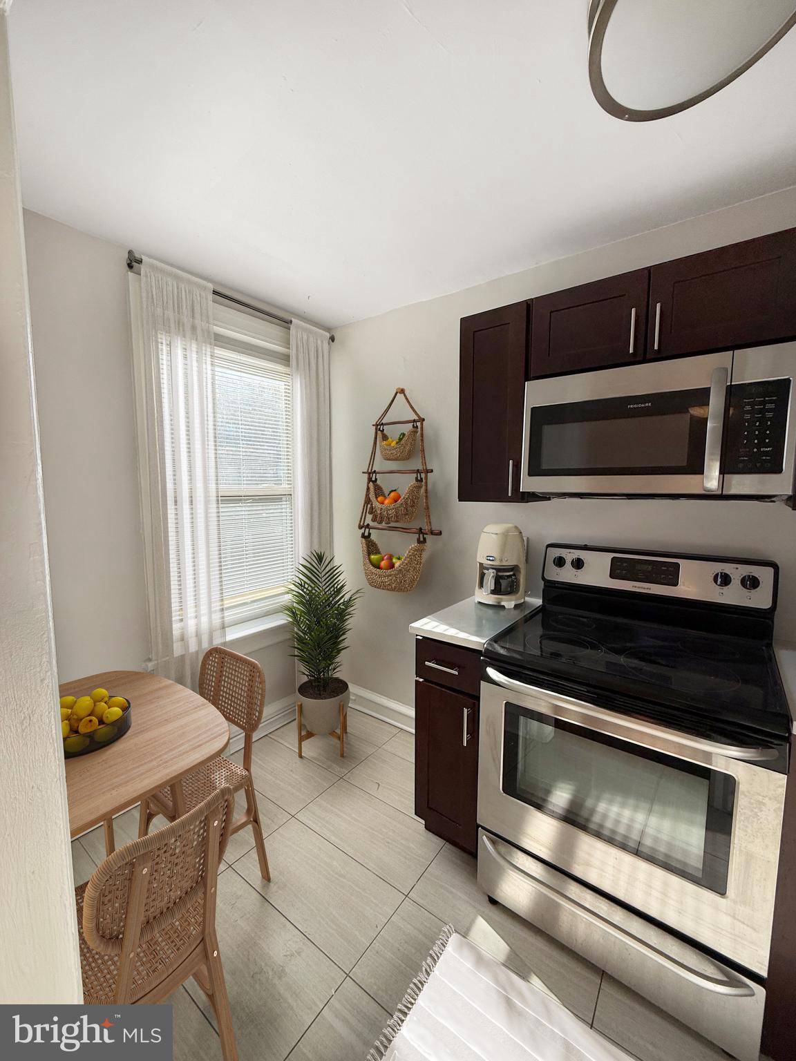 4605 Chester Avenue, Unit STUDIO Philadelphia, PA 19143 - Photo 3 of 12 a kitchen with a stove and a microwave