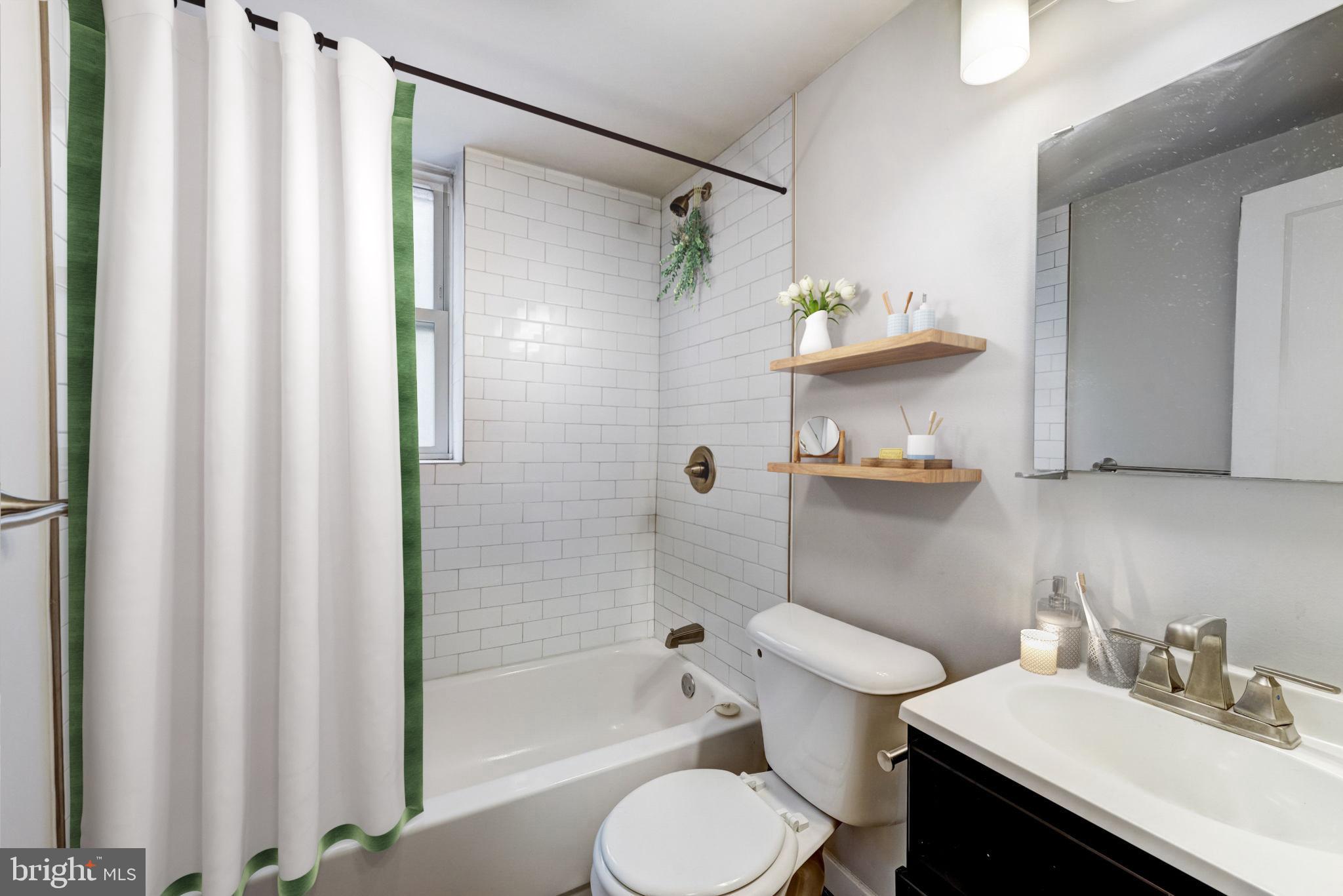4605 Chester Avenue, Unit STUDIO Philadelphia, PA 19143 - Photo 5 of 12 a bathroom with a sink toilet and shower