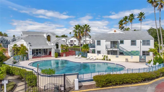 a view of a house with backyard and sitting area