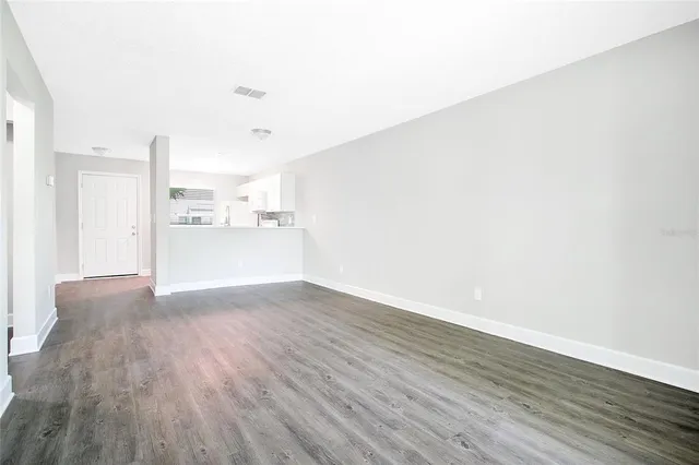 a view of a kitchen with wooden floor and a sink