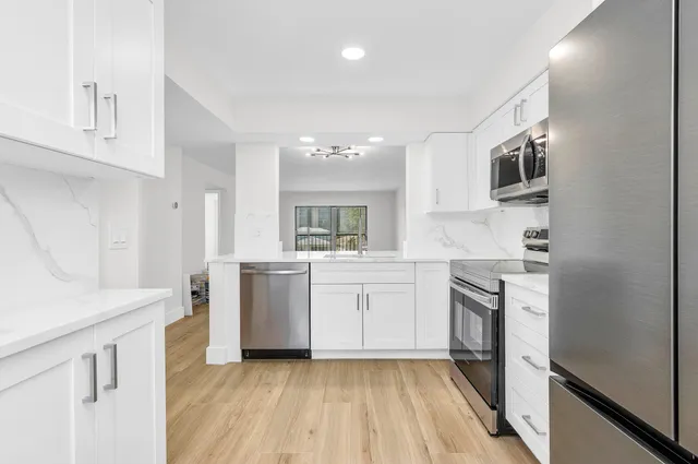 a kitchen with a sink stove and refrigerator