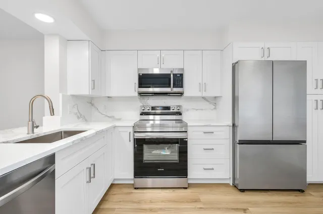 a kitchen with a sink stove and refrigerator