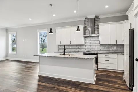 a kitchen with a sink stove and refrigerator