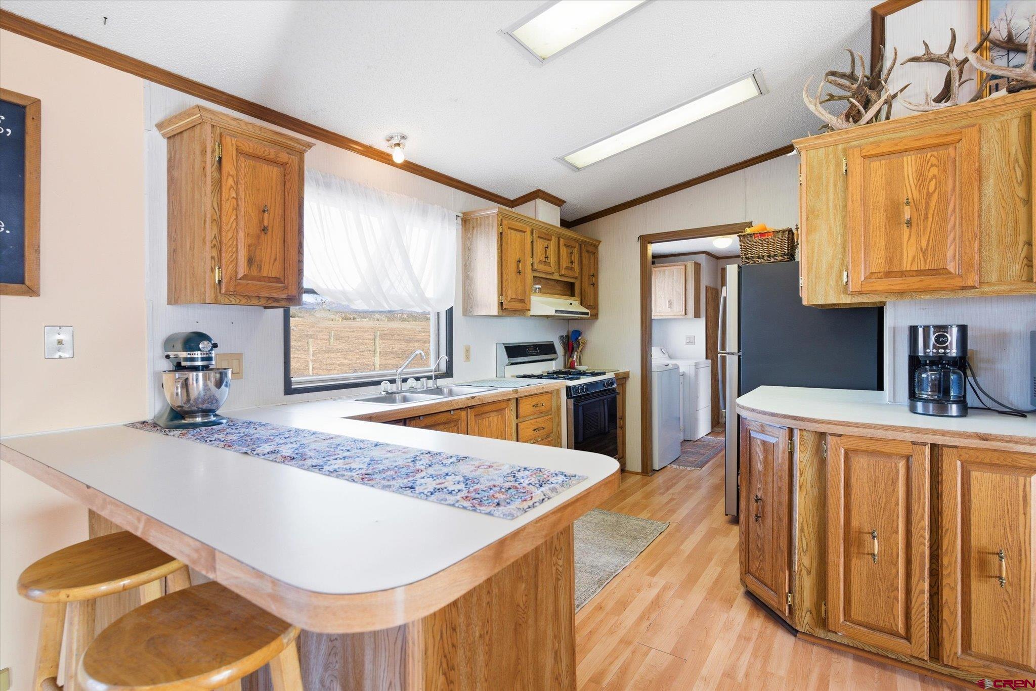 1966 County Road 321 Ignacio, CO 81137 - Photo 4 of 26 a kitchen with stainless steel appliances granite countertop a sink refrigerator and cabinets