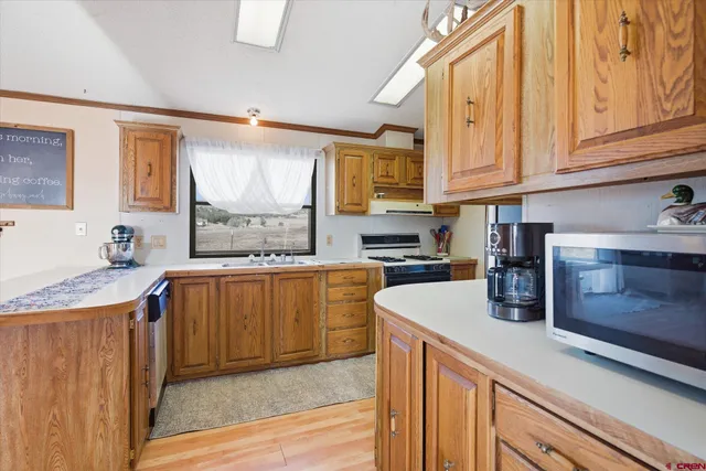a kitchen with granite countertop cabinets stainless steel appliances a sink and a window