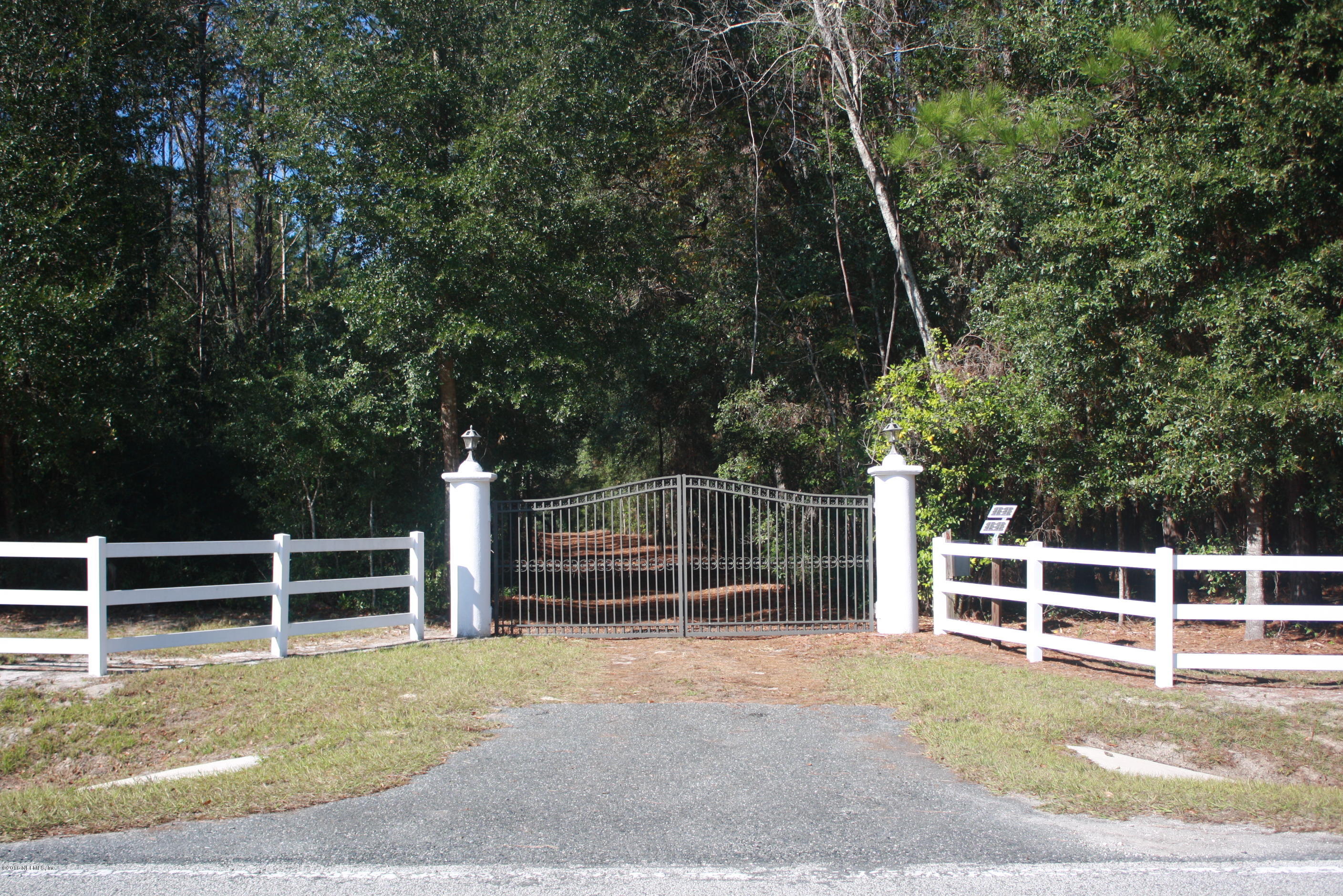 301 Georgetown Shortcut Road Crescent City, FL 32112 - Photo 11 of 108 a view of backyard with wooden fence and a large window