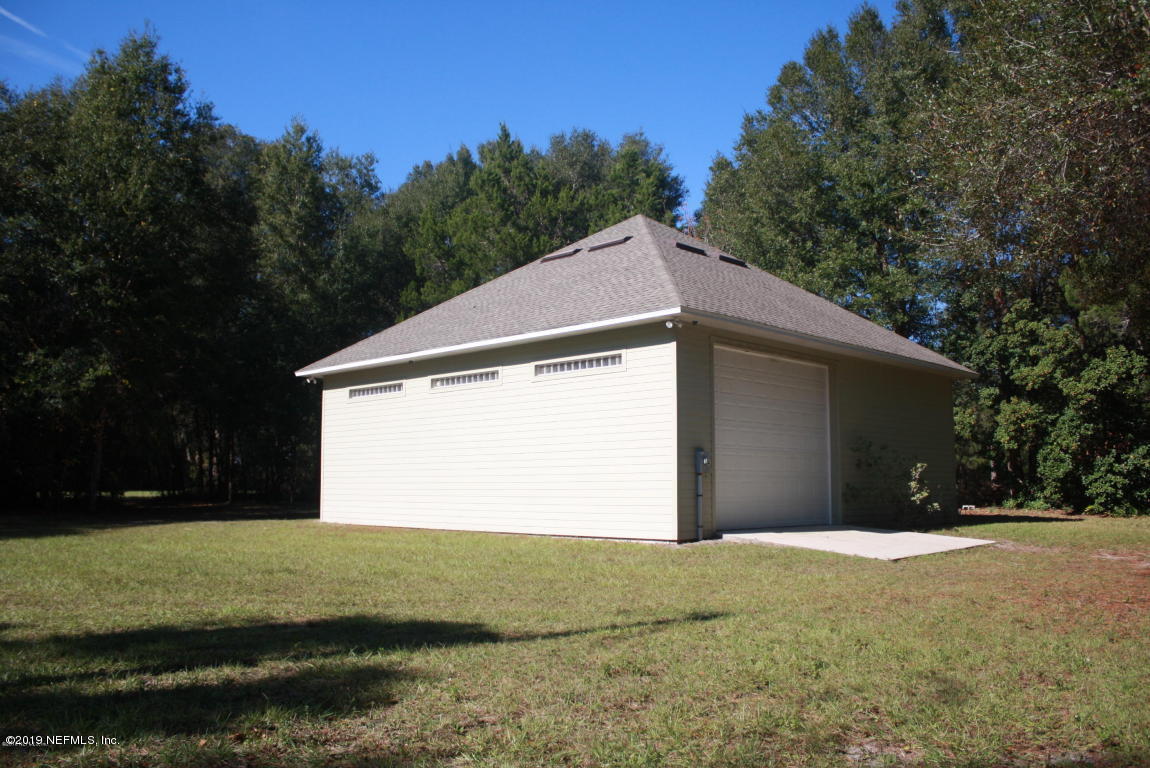 301 Georgetown Shortcut Road Crescent City, FL 32112 - Photo 3 of 108 a front view of a house with a yard and garage