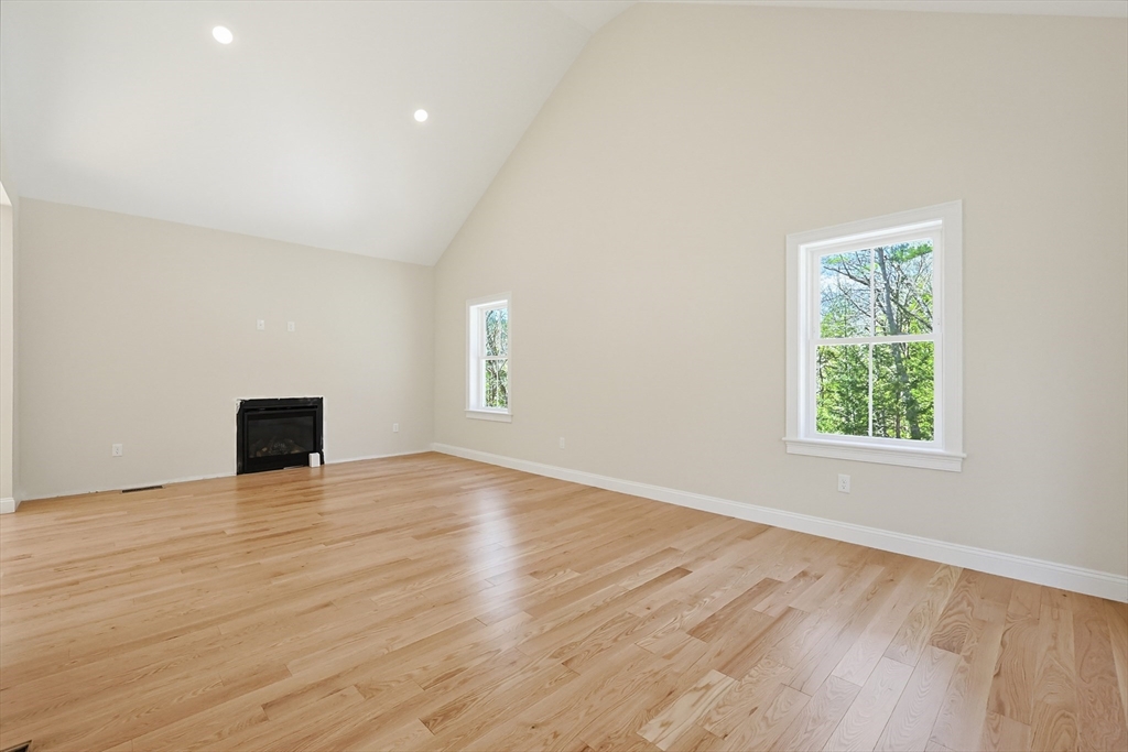 112 West Meadow Road Townsend, MA 01474 - Photo 12 of 38 an empty room with wooden floor and windows