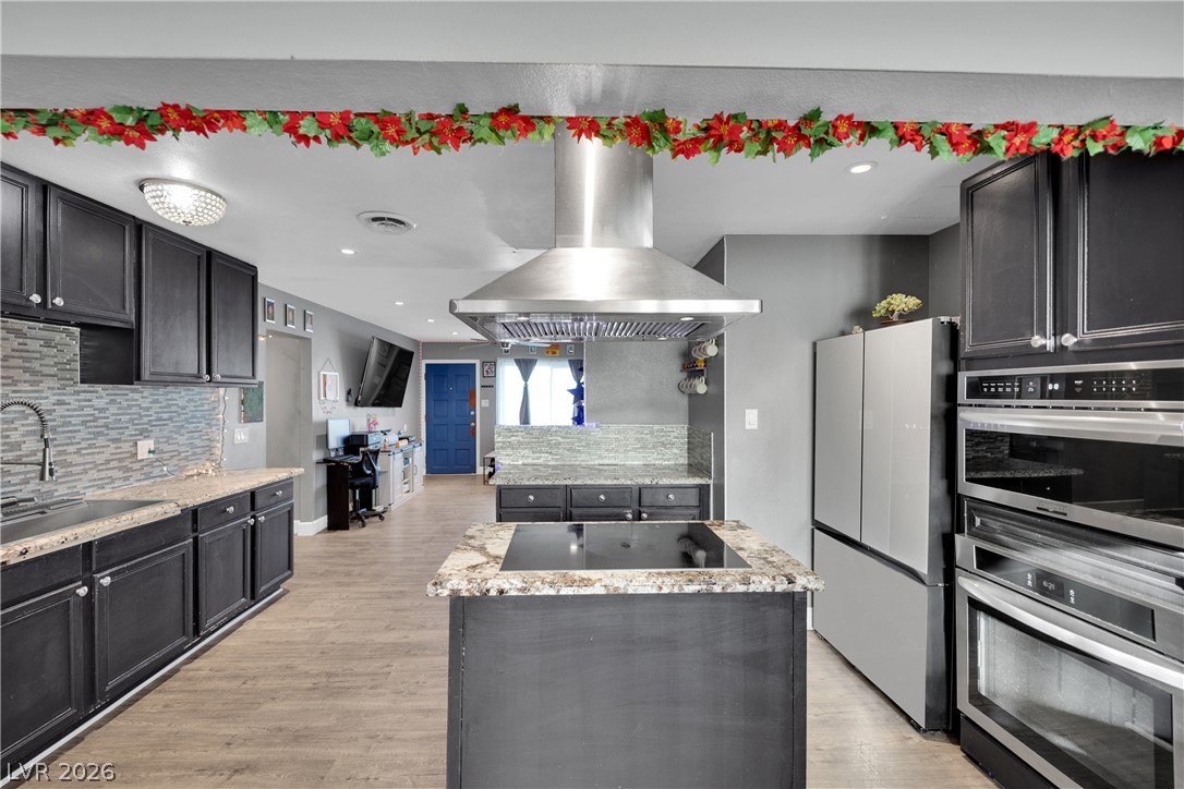2221 Englestad Street North Las Vegas, NV 89030 - Photo 8 of 32 Culinary excellence awaits in this kitchen featuring a island cooktop.