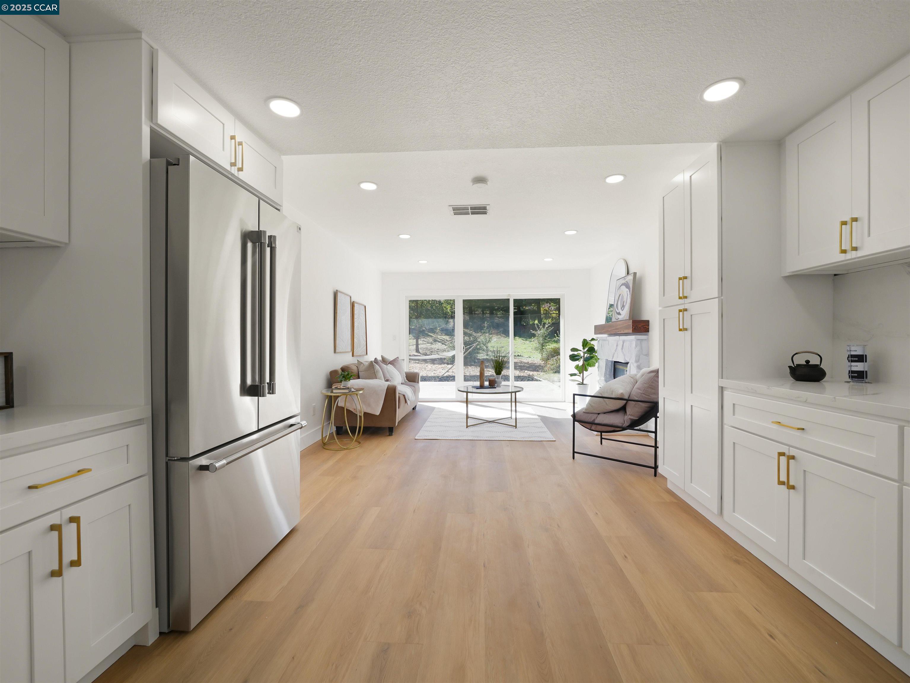 2482 Wildhorse Drive San Ramon, CA 94583 - Photo 12 of 41 a large white kitchen with stainless steel appliances