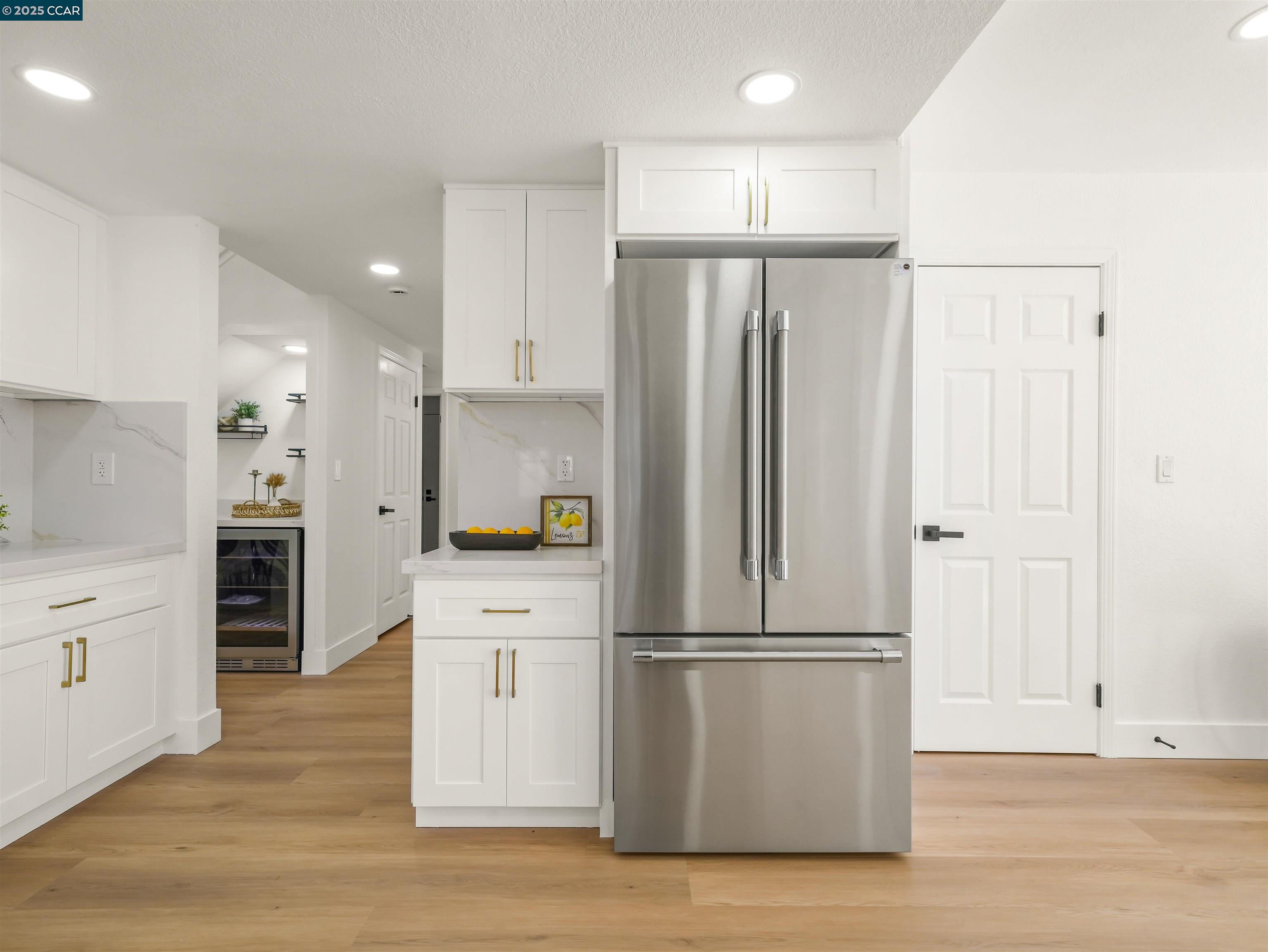 2482 Wildhorse Drive San Ramon, CA 94583 - Photo 15 of 41 a kitchen with kitchen island white cabinets stainless steel appliances and wooden floor