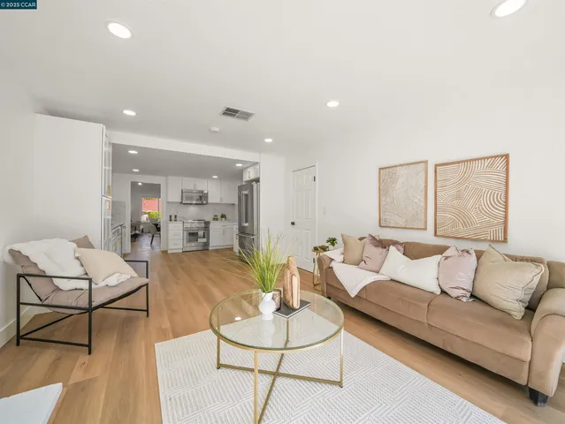 a living room with furniture and kitchen view