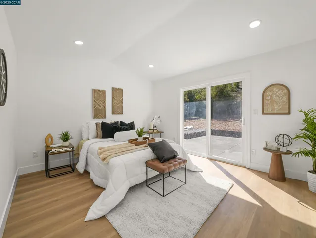 a spacious bedroom with a bed and glass door