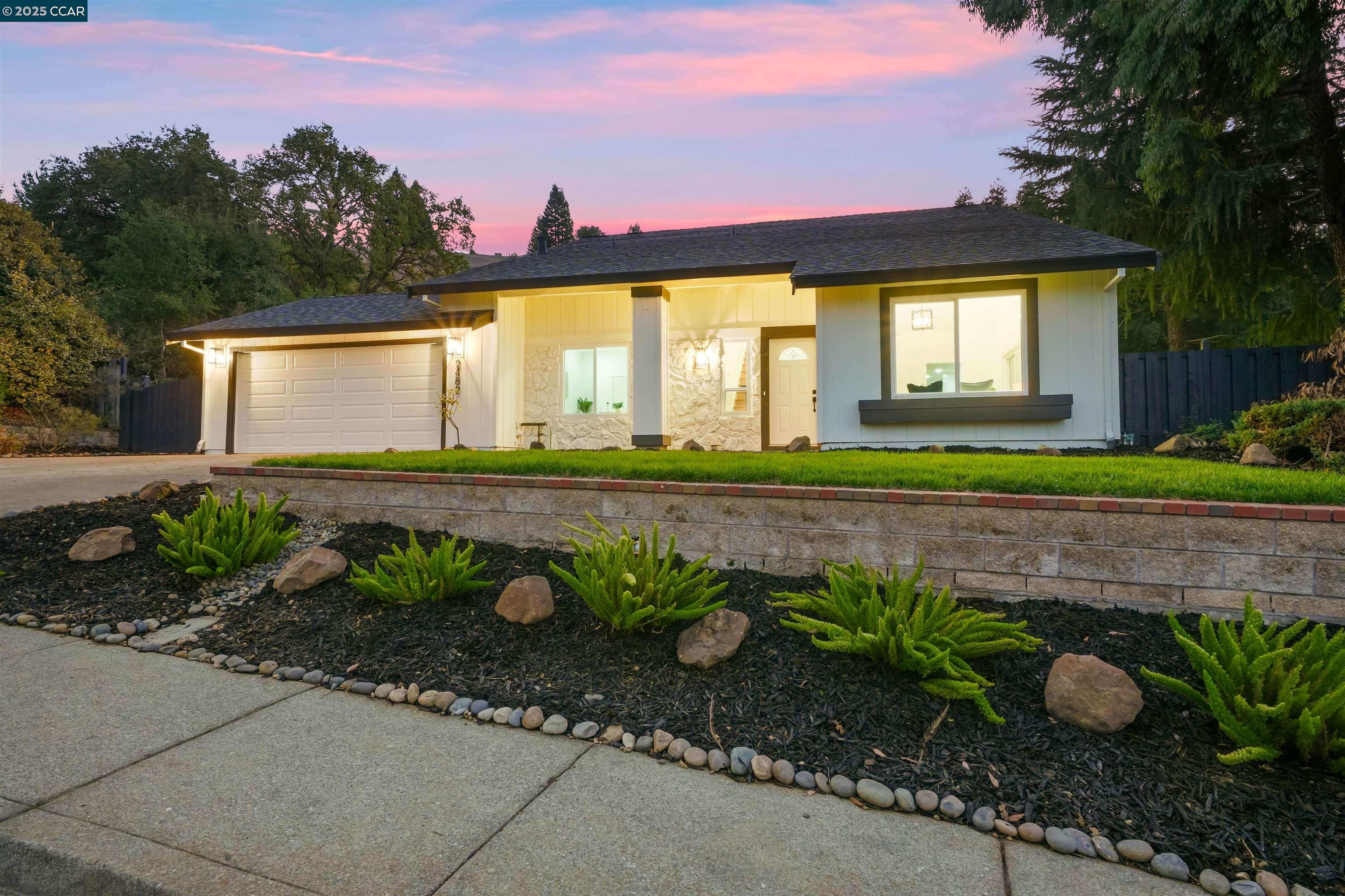 2482 Wildhorse Drive San Ramon, CA 94583 - Photo 2 of 41 a front view of a house with a yard and potted plants