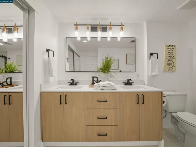 a bathroom with a sink a toilet and mirror