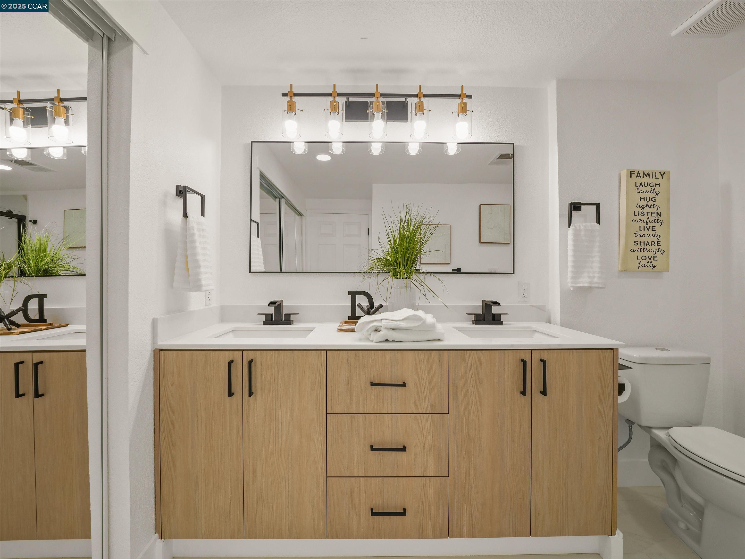 2482 Wildhorse Drive San Ramon, CA 94583 - Photo 21 of 41 a bathroom with a sink a toilet and mirror