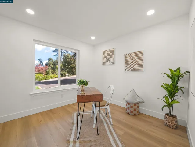 a view of a livingroom with furniture and a potted plant