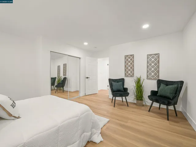 a bedroom with a bed and chair