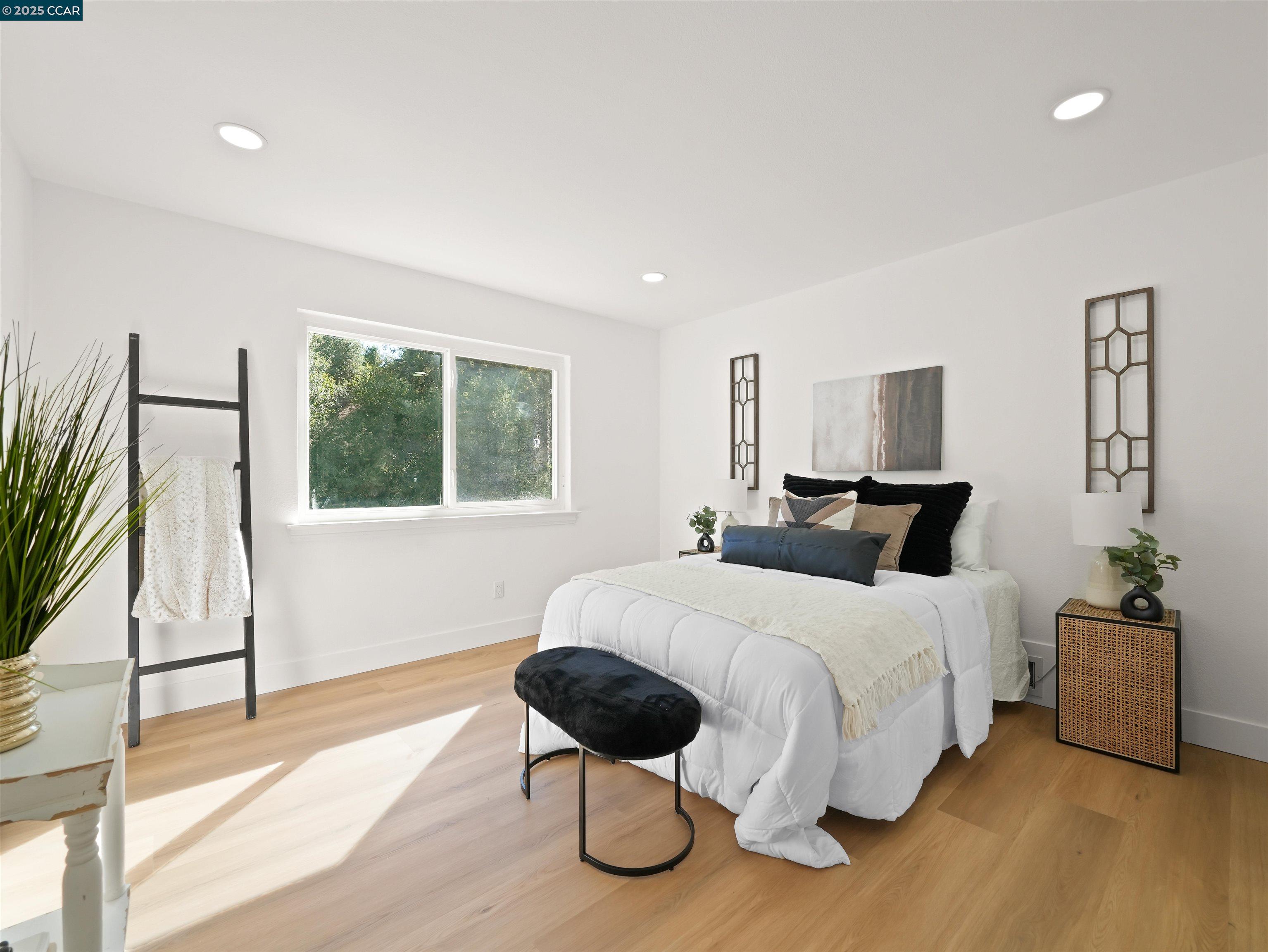 2482 Wildhorse Drive San Ramon, CA 94583 - Photo 28 of 41 a bedroom with a bed lamp and a large window with wooden floor