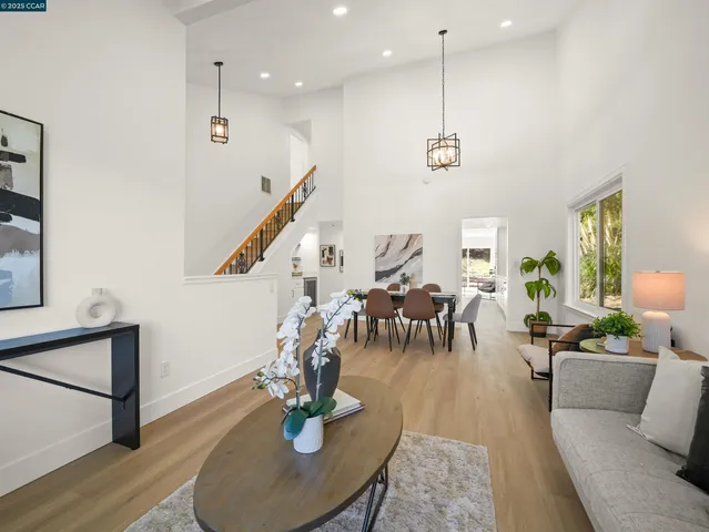 a living room with lots of furniture and a wooden floor