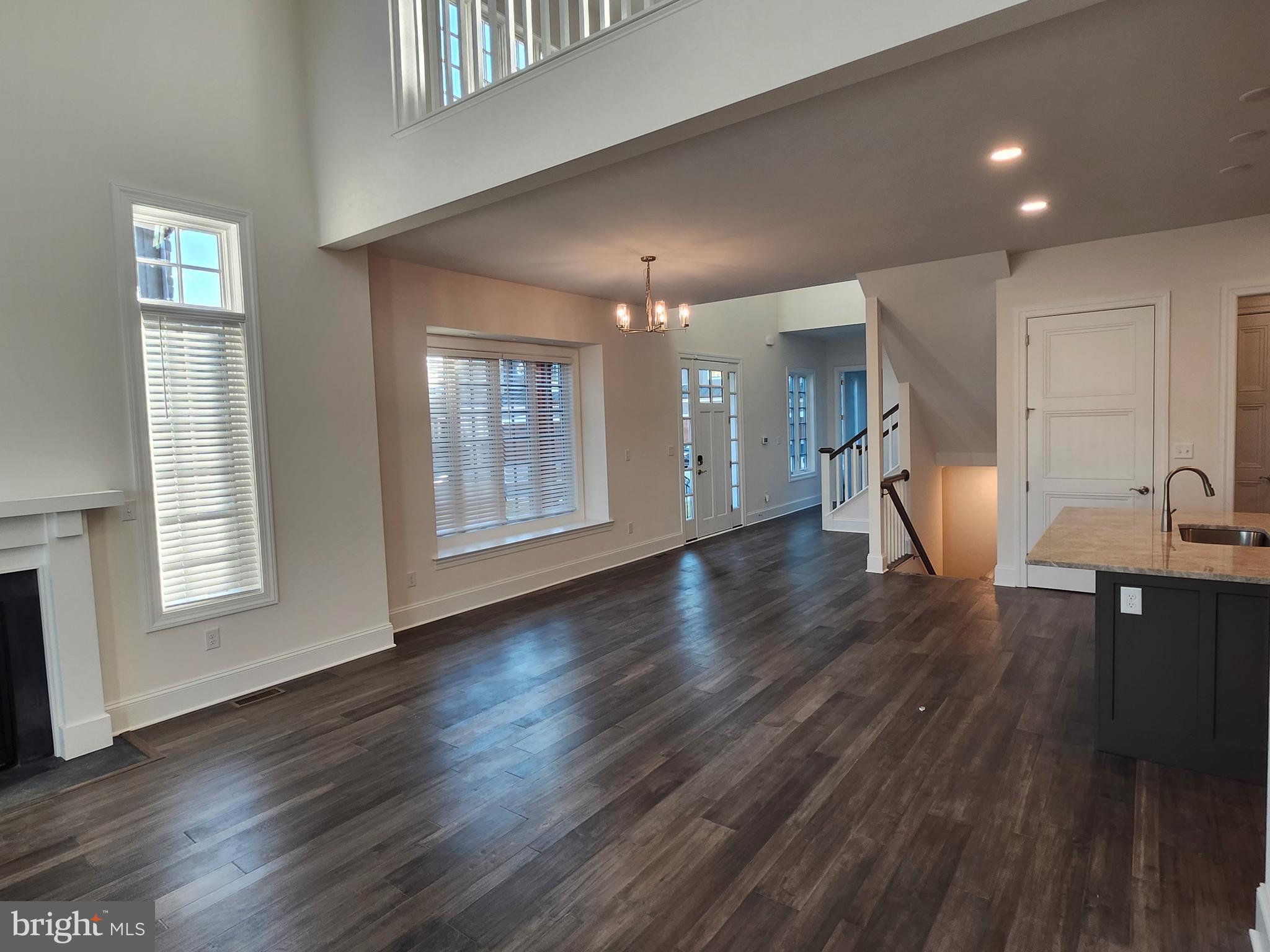 1105 Invermere Road Wilmington, DE 19803 - Photo 2 of 11 a view of an empty room with a kitchen and wooden floor